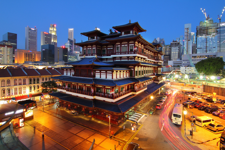 Chinatown, Singapore – July 29, 2017: Buddha Toothe Relic Temple in Chinatown in Singapore, with Singapore`s business district in the background is a beautiful location and very popular for tourists.