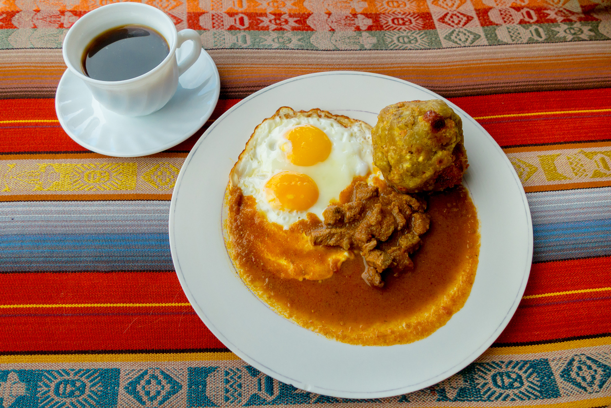 Bolon de verde with fried egg and meat stew ecuadorian