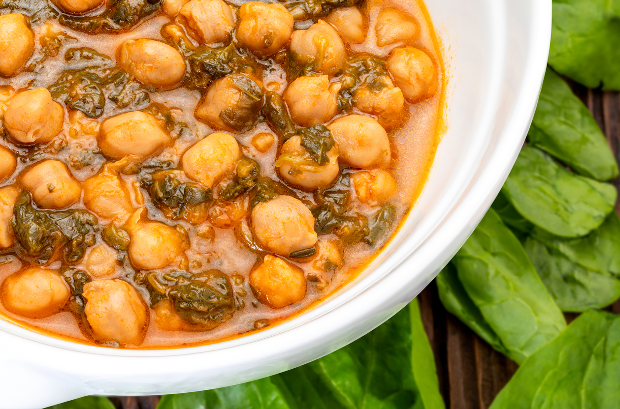 Chickpea stew with spinach (potaje). Delicious spoon dish for autumn and winter. Traditional food. Foreground.