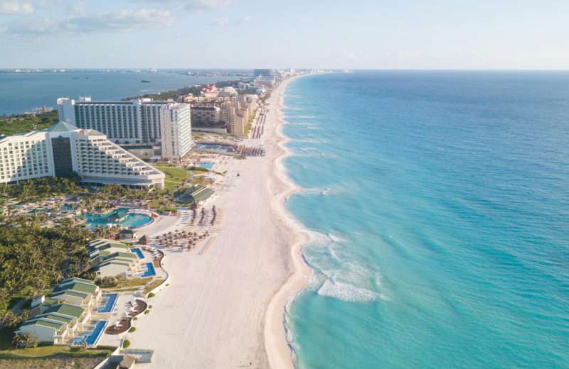 Tourists dip their toes in water as top Mexican beach getaway reopens